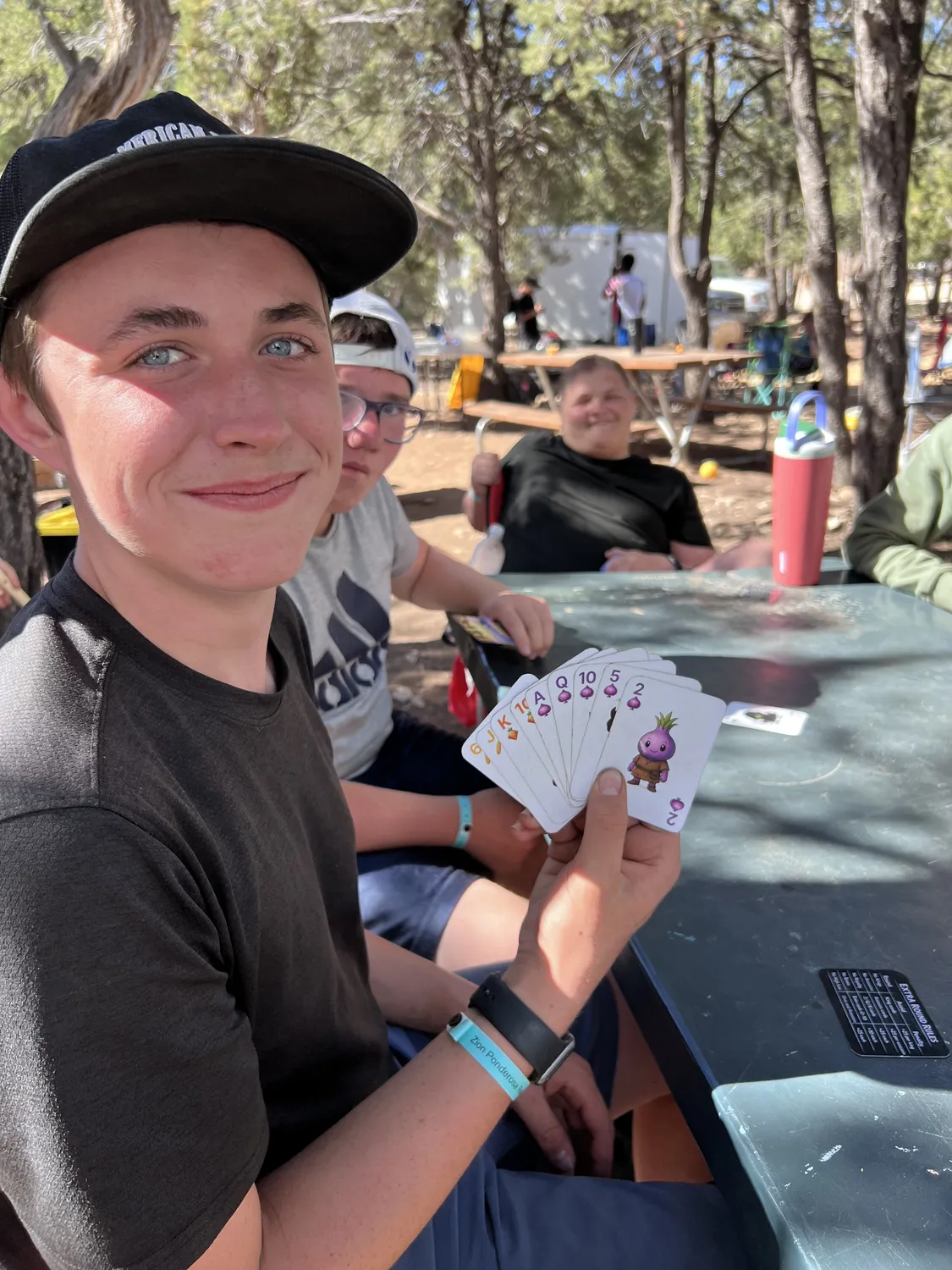 Friends playing Skip the Salad! at a campsite